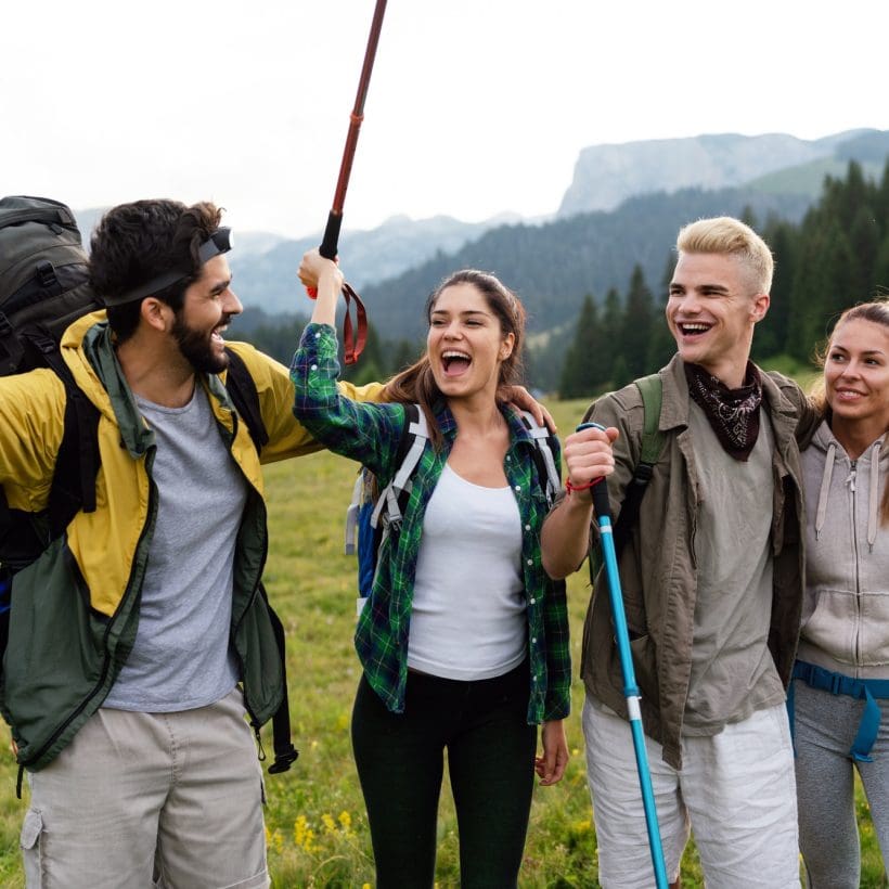 group-of-friends-trekking-with-backpacks-walking-in-the-forest.jpg